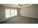 Large bedroom with carpet flooring, a ceiling fan, and natural light coming through the windows at 942 Idlewood Dr, Canton, GA 30115