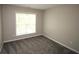 Cozy bedroom showcasing soft carpeting and a window that fills the room with natural light at 942 Idlewood Dr, Canton, GA 30115