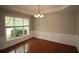 Dining room featuring hardwood floors, a large window, decorative molding, and a chandelier at 942 Idlewood Dr, Canton, GA 30115