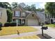 Charming two-story home with an attached two-car garage and a well-manicured lawn at 942 Idlewood Dr, Canton, GA 30115