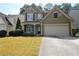 Charming two-story home with a well-maintained lawn and two car garage at 942 Idlewood Dr, Canton, GA 30115