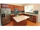 Well-equipped kitchen features stainless steel appliances, dark cabinets, an island, and hardwood floors at 942 Idlewood Dr, Canton, GA 30115