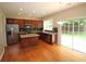Open kitchen with stainless steel appliances, dark cabinets, island, and sliding glass doors to the outside at 942 Idlewood Dr, Canton, GA 30115
