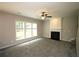 Spacious living room with a fireplace, carpeted floors, and large windows that let in natural light at 942 Idlewood Dr, Canton, GA 30115
