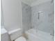 Stylish bathroom features elegant gray-toned marble wall tile, a recessed shower caddy, and a bathtub for relaxation at 159 Aztec Se Way, Acworth, GA 30102