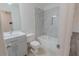 Inviting bathroom has gray wall tiles in the shower, a toilet, a sink with vanity, and light flooring at 159 Aztec Se Way, Acworth, GA 30102