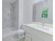 A contemporary bathroom features a shower with marbled tiling and a vanity with ample storage and counter space at 159 Aztec Se Way, Acworth, GA 30102