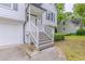 Close up of a two-story home with white siding, dark shutters, attached garage, steps and walkway at 159 Aztec Se Way, Acworth, GA 30102