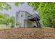 Rear exterior of the home featuring an elevated deck with stairs to yard at 159 Aztec Se Way, Acworth, GA 30102