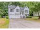 Two-story home with white siding, dark shutters, attached garage and surrounded by lush greenery at 159 Aztec Se Way, Acworth, GA 30102