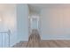 Hallway with hardwood floors and white walls leading into various rooms at 159 Aztec Se Way, Acworth, GA 30102