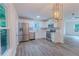 Modern kitchen features stainless steel appliances, white cabinets, hardwood floors, and backyard views at 159 Aztec Se Way, Acworth, GA 30102