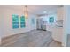Modern kitchen with stainless steel appliances, white cabinets, hardwood floors, and backyard views at 159 Aztec Se Way, Acworth, GA 30102