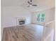 Bright living room with stone fireplace, vaulted ceiling, hardwood floors, and natural light from a large window at 159 Aztec Se Way, Acworth, GA 30102