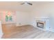 Bright living room featuring a stone fireplace, hardwood floors, and ample natural light at 159 Aztec Se Way, Acworth, GA 30102