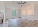 Bright living room featuring a stone fireplace, hardwood floors, modern ceiling fan, and ample natural light at 159 Aztec Se Way, Acworth, GA 30102