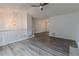 Spacious living room featuring hardwood floors, modern ceiling fan, stone fireplace, and ample natural light at 159 Aztec Se Way, Acworth, GA 30102