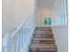 Bright staircase with hardwood stairs, white railing, and ample natural light at 159 Aztec Se Way, Acworth, GA 30102
