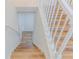 Bright staircase with hardwood stairs, white railing, and access to the upper level at 159 Aztec Se Way, Acworth, GA 30102