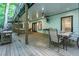 Expansive back porch with ample seating, ceiling fans, and outdoor TV at 3924 Ashford Dunwoody Road Northeast Ne Rd, Atlanta, GA 30319