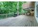 Back porch and outdoor kitchen with built in grill, table, seating, and natural view at 3924 Ashford Dunwoody Road Northeast Ne Rd, Atlanta, GA 30319