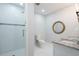 Bright bathroom featuring a sleek shower, round mirror, and granite vanity top at 3924 Ashford Dunwoody Road Northeast Ne Rd, Atlanta, GA 30319