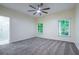 Bright bedroom with a ceiling fan and windows offering scenic wooded views at 3924 Ashford Dunwoody Road Northeast Ne Rd, Atlanta, GA 30319