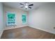 Bedroom with neutral walls, wood flooring, and large windows with blinds at 3924 Ashford Dunwoody Road Northeast Ne Rd, Atlanta, GA 30319