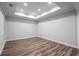 Bedroom with tray ceiling, recessed lights and wood-look vinyl floors at 3924 Ashford Dunwoody Road Northeast Ne Rd, Atlanta, GA 30319