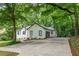 Home exterior with extended driveway and beautiful green trees at 3924 Ashford Dunwoody Road Northeast Ne Rd, Atlanta, GA 30319