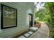 Side exterior view with walkway leading to entrance and window with black trim at 3924 Ashford Dunwoody Road Northeast Ne Rd, Atlanta, GA 30319