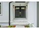 Close up of the stately, black, double front door with a stone path at 3924 Ashford Dunwoody Road Northeast Ne Rd, Atlanta, GA 30319