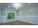 Bright living room featuring large windows, decorative molding, and hardwood floors at 3924 Ashford Dunwoody Road Northeast Ne Rd, Atlanta, GA 30319