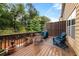 Outdoor back deck with wooden railing, seating, grill and view of wooded backyard at 3937 Covey Flush Sw Ct # 25, Smyrna, GA 30082