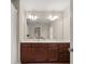 Bright bathroom with a large mirror, double sinks, dark wood cabinets and fixtures at 3937 Covey Flush Sw Ct # 25, Smyrna, GA 30082