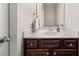 Traditional bathroom with a dark wood vanity, white countertop, and decorative hardware at 3937 Covey Flush Sw Ct # 25, Smyrna, GA 30082
