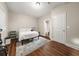 Bright bedroom featuring a sleek metal bed frame and view of the en-suite bathroom at 3937 Covey Flush Sw Ct # 25, Smyrna, GA 30082