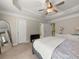 Cozy bedroom featuring a ceiling fan, ensuite bathroom, and large mirror at 3937 Covey Flush Sw Ct # 25, Smyrna, GA 30082