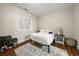 Cozy bedroom with a simple metal bed frame and an area rug on hardwood floors at 3937 Covey Flush Sw Ct # 25, Smyrna, GA 30082