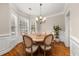 Bright dining room featuring a bay window, hardwood floors, and a charming chandelier at 3937 Covey Flush Sw Ct # 25, Smyrna, GA 30082