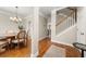 Elegant foyer with hardwood floors, chandelier, staircase, and dining area with an adjacent kitchen at 3937 Covey Flush Sw Ct # 25, Smyrna, GA 30082