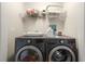 Modern laundry room with front load washer and dryer and wire rack for storage at 3937 Covey Flush Sw Ct # 25, Smyrna, GA 30082