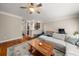 Bright living room with hardwood floors, ceiling fan, a modern sectional sofa, and a view to the kitchen at 3937 Covey Flush Sw Ct # 25, Smyrna, GA 30082