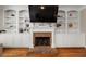 Cozy living room featuring built-in shelving surrounding a fireplace and hardwood floors at 3937 Covey Flush Sw Ct # 25, Smyrna, GA 30082