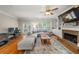 Bright living area with hardwood flooring, fireplace, built-in bookshelves, and a comfortable sectional sofa at 3937 Covey Flush Sw Ct # 25, Smyrna, GA 30082