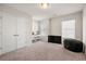 Bedroom featuring neutral carpet, modern light fixture and a double window at 6372 Rosetta Sw Dr, Atlanta, GA 30331