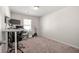 Bedroom featuring neutral carpet, modern light fixture and a large window at 6372 Rosetta Sw Dr, Atlanta, GA 30331