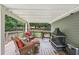 Enjoy relaxing on this covered back deck with wicker furniture and fire pit at 10875 Shagbark Trl, Roswell, GA 30075