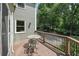Enjoy wooded views from this back deck with bistro table and chairs at 10875 Shagbark Trl, Roswell, GA 30075