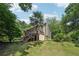 Spacious backyard of home with tiered decks and stairs surrounded by trees at 10875 Shagbark Trl, Roswell, GA 30075